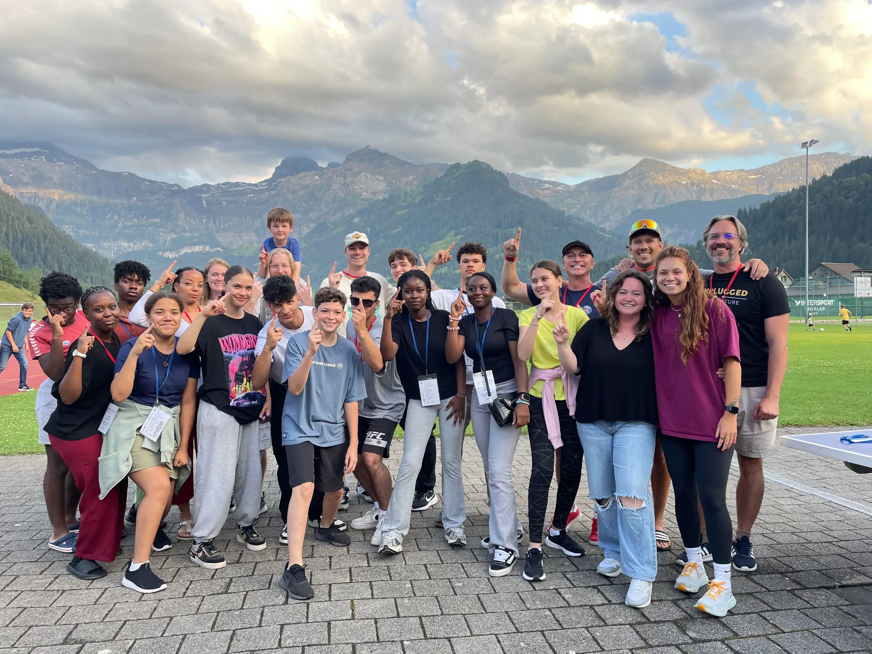 Group of youth from our church at the last camp, with kids and the pastor in front of mountains